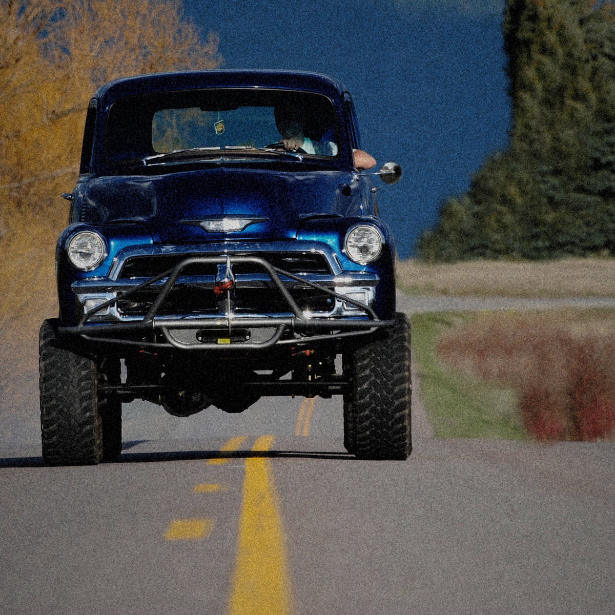 Flathead Valley 406 Montana: lifted 1954 Chevy pickup on a two-lane road